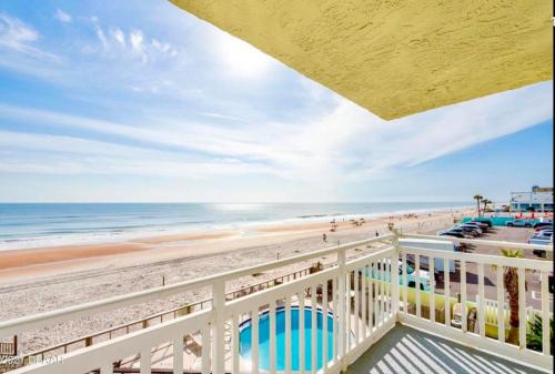 a view of the beach from a balcony at Beachfront Bliss - Suite at Symphony Beach Club in Ormond Beach