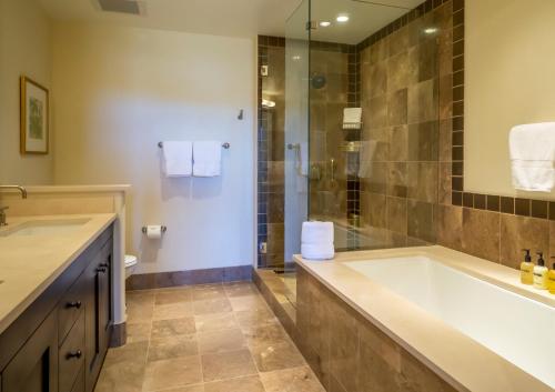 a bathroom with a large tub and a shower at Edgemont 2401 - Luxury Ski-in Ski-out Condo in Steamboat Springs