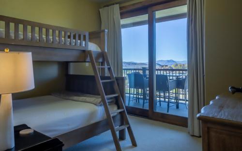 a bedroom with a bunk bed and a balcony at Edgemont 2401 - Luxury Ski-in Ski-out Condo in Steamboat Springs