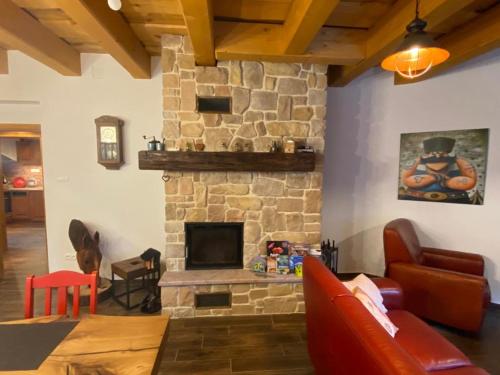 a living room with a stone fireplace at Chata Klinger in Banská Štiavnica