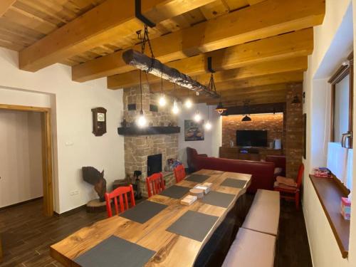 a dining room with a table and a fireplace at Chata Klinger in Banská Štiavnica