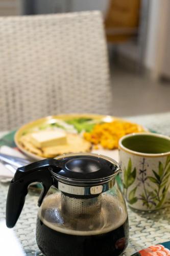 a tea pot and a cup of coffee on a table at Zentrico Boutique in Pereira