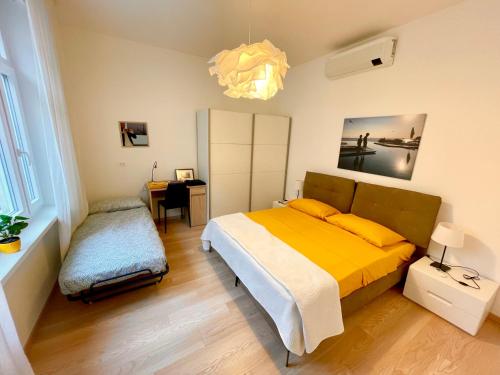 a bedroom with a bed and a desk in it at Residence Neverin Trieste in Trieste