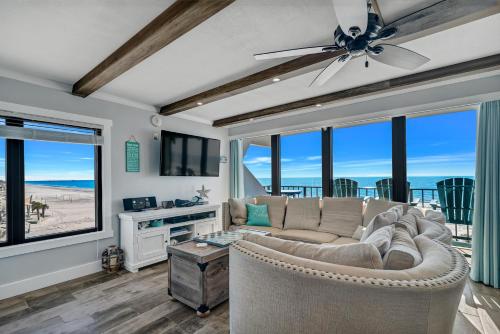 a living room with a couch and a ceiling fan at Island Winds East Unit 401 in Gulf Shores