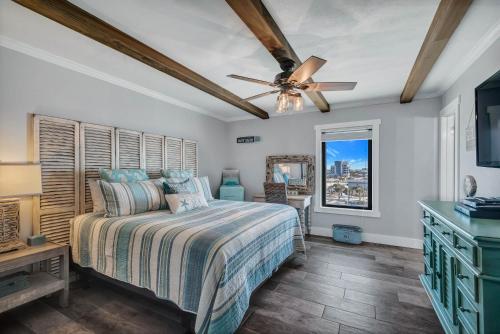 a bedroom with a bed and a ceiling fan at Island Winds East Unit 401 in Gulf Shores