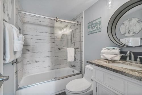 a bathroom with a tub and a toilet and a sink at Island Winds East Unit 401 in Gulf Shores