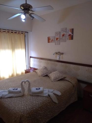 a bedroom with a bed with two towels on it at Hotel Neptuno in Miramar