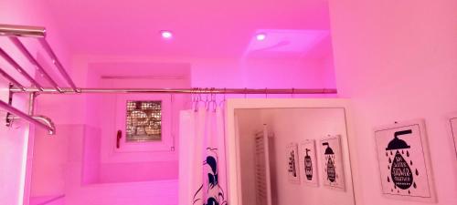 a room with pink lights on the ceiling at DEEP BLUE LAKE in Argegno