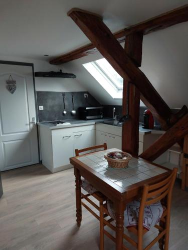 une cuisine avec une table et des chaises dans une pièce dans l'établissement Les Marmottes, à Les Étalons