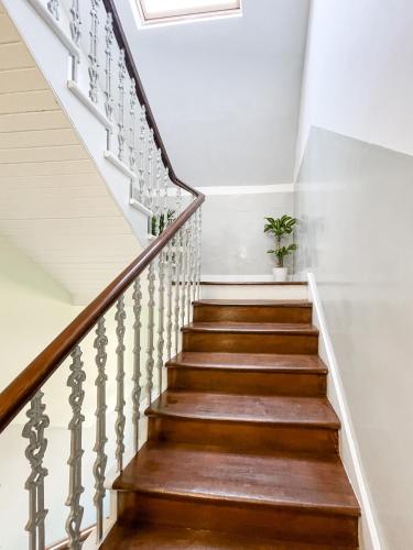 a staircase with wooden treads and a skylight at The Penthouse in Oban
