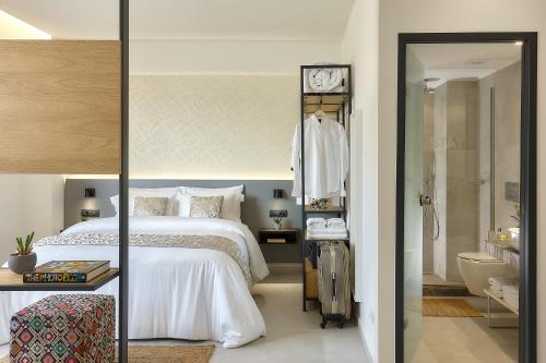 a bedroom with a bed and a bathroom at Stay 365 Heraklion Apart Hotel in Heraklio Town