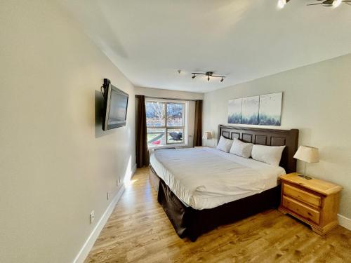 a bedroom with a large bed and a window at Best ski in ski out condo at Whistler in Whistler