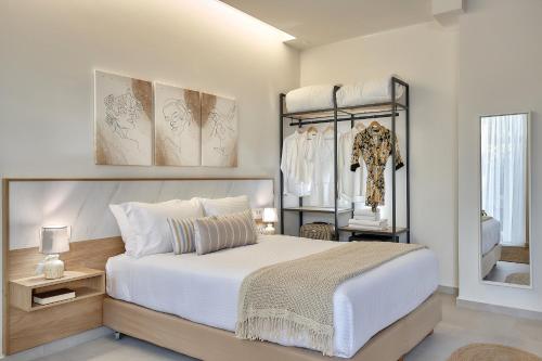 a bedroom with a bed and a dressing room at Stay 365 Heraklion Apart Hotel in Heraklio Town