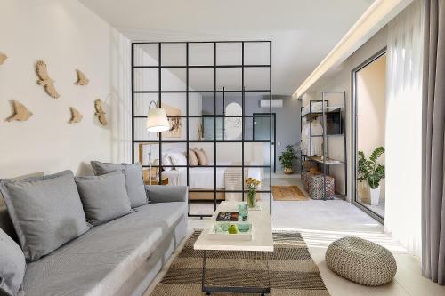 a living room with a couch and a table at Stay 365 Heraklion Apart Hotel in Heraklio Town