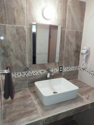 a bathroom with a white sink and a mirror at Loft Solimán - Netflix - HBO - Near Market 28 - Downtown in Cancún