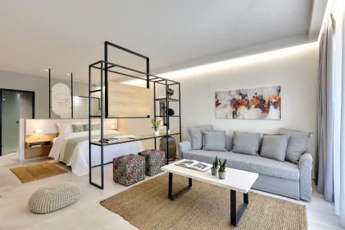 a living room with a couch and a bed at Stay 365 Heraklion Apart Hotel in Heraklio Town