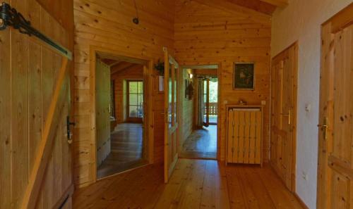 a hallway of a wooden cabin with wooden floors at Gästehaus Pfeffererlehen in Marktschellenberg