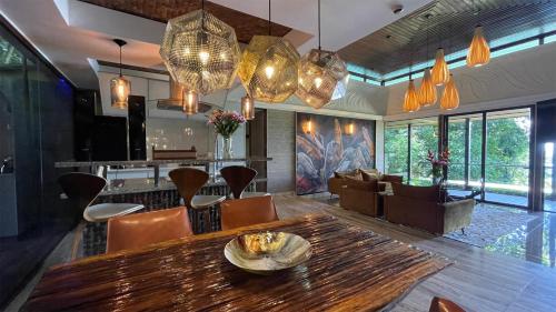 a living room with a wooden table and chairs at Makanda by The Sea Hotel Adults Only in Manuel Antonio