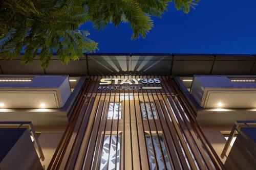 a building with a starbucks sign on the side at Stay 365 Heraklion Apart Hotel in Heraklio Town