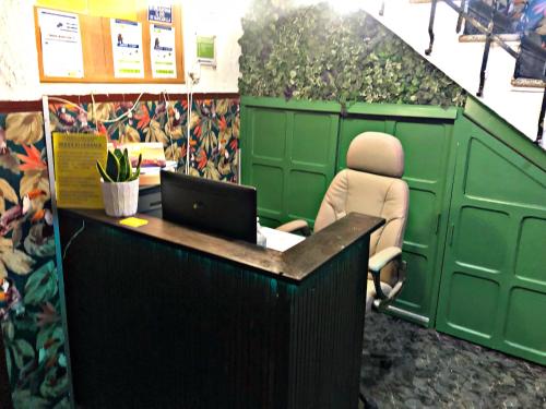 a person sitting at a desk with a laptop at Barbieri Granada Pensión in Granada