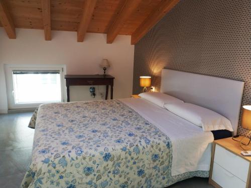 a bedroom with a large bed and a window at sweet homes in Lecco