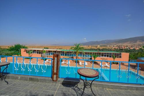 a view of a swimming pool with tables and chairs at L'oliveraie D'amizmiz in Amizmiz