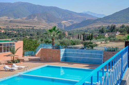a swimming pool with a view of the mountains at L'oliveraie D'amizmiz in Amizmiz