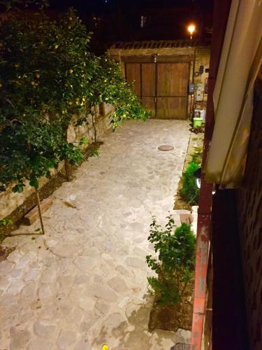 a stone walkway in a backyard at night at Dzveli Galavani -Old Wall in Tʼelavi
