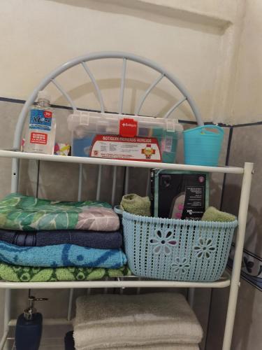 a shelf with a basket and other items on it at Greenhouse Lofts Miravalles in Aguas Claras