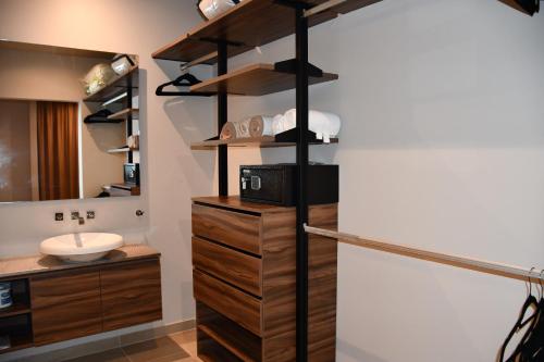 a bathroom with a sink and a toilet in it at Kaab At The Park by The Spot Rentals in Playa del Carmen