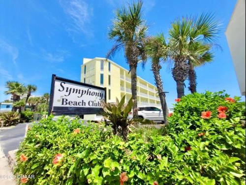 a sign for a beach club in front of a building at Just Beachy -Ocean View at Symphony Beach Club in Ormond Beach