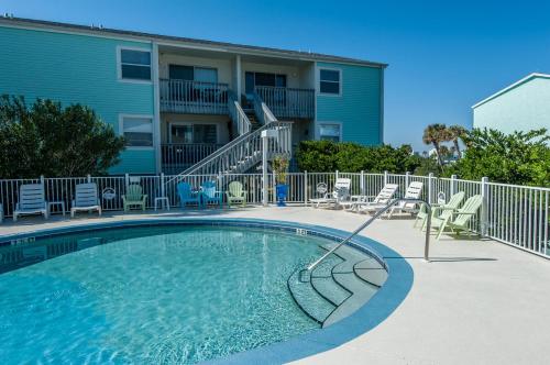 a swimming pool in front of a building at Villas on the Gulf unit J7 in Pensacola Beach