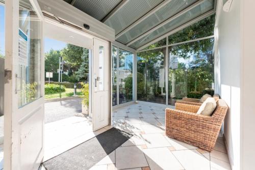 a screened in porch with a couch and windows at Résidence Pierre & Vacances La Rostagne in Juan-les-Pins