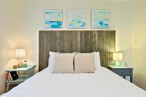 a bedroom with a large white bed and two tables at Mission Beach Getaway Condo in San Diego