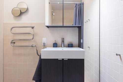 a bathroom with a sink and a mirror at Cozy place in Vilnius Old Town in Vilnius