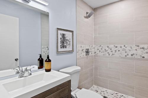 a bathroom with a sink and a toilet and a shower at Upgraded 2BR Residence with Bikes, Steps to Sanibel Lighthouse in Sanibel