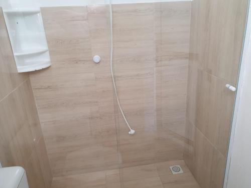 a shower with a white hose in a bathroom at Pousada Korb in Santo Amaro da Imperatriz