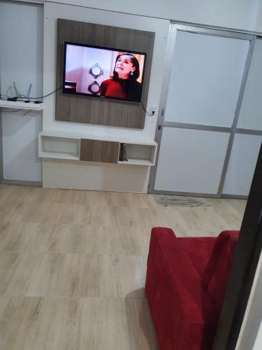 a living room with a flat screen tv on a wall at Pousada Korb in Santo Amaro da Imperatriz