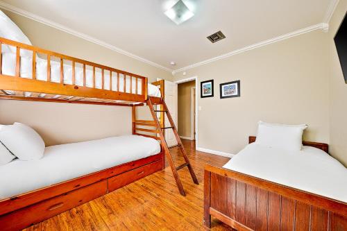 two bunk beds in a room with wooden floors at Disney Getaway in Anaheim