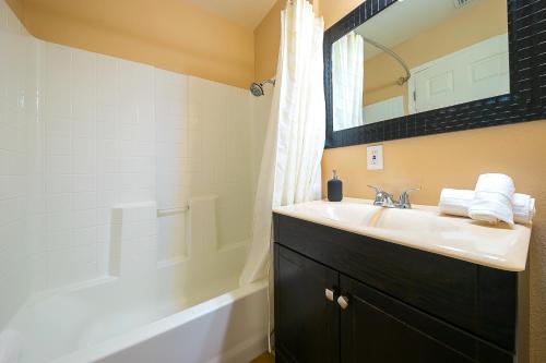 a bathroom with a sink and a mirror at Disney Getaway in Anaheim
