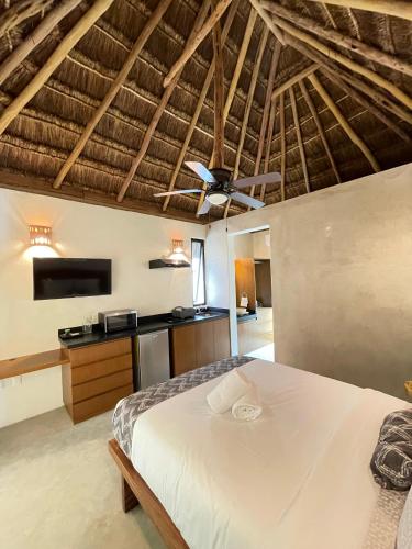 a bedroom with a bed and a ceiling fan at The Reserve Tulum in Tulum
