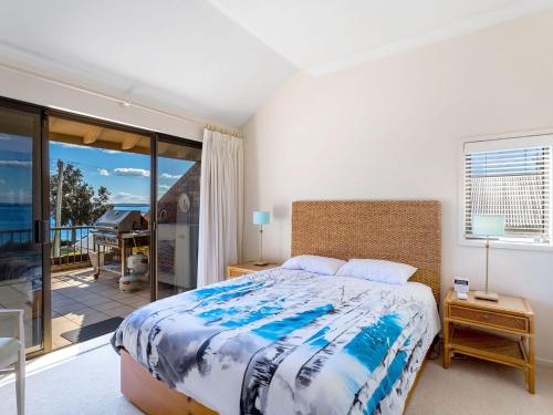 a bedroom with a bed and a view of the ocean at A Yachtsmans Rest, Unit 4/37 Victoria Parade in Nelson Bay