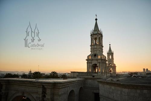 an old building with a clock tower at sunset at Catedral in Arequipa