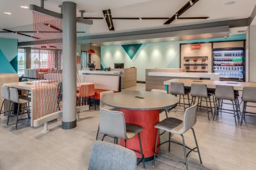 a restaurant with tables and chairs and a bar at avid hotels - Zeeland by IHG in Holland