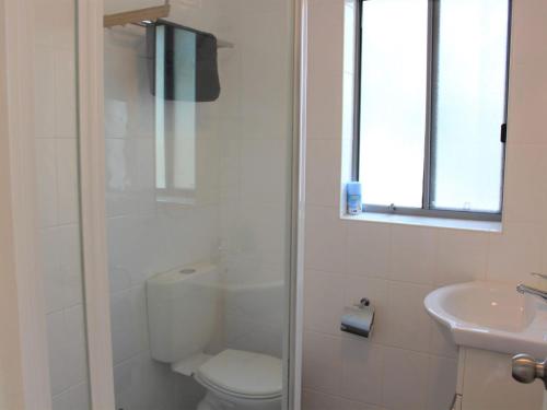 a bathroom with a toilet and a sink at Sand Sea 5 in Sawtell