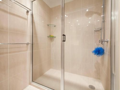 a shower with a glass door in a bathroom at Kamilaroi, 6/58-60 Magnus Street in Nelson Bay