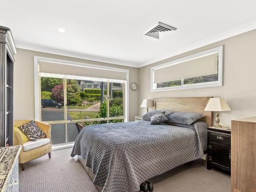 a bedroom with a bed and a window at Private coastal getaway Corlette in Corlette