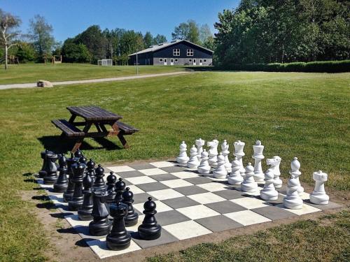 a chess board and a bench in a park at 6 person holiday home in Tranek r in Tranekær