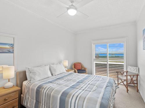 a white bedroom with a bed and a window at Bella Vista Unit 22 19 Shoal Bay Road in Shoal Bay