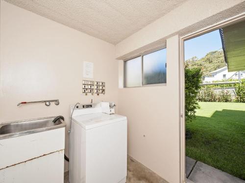 a laundry room with a sink and a dishwasher at Bella Vista Unit 3 19 Shoal Bay Road in Shoal Bay